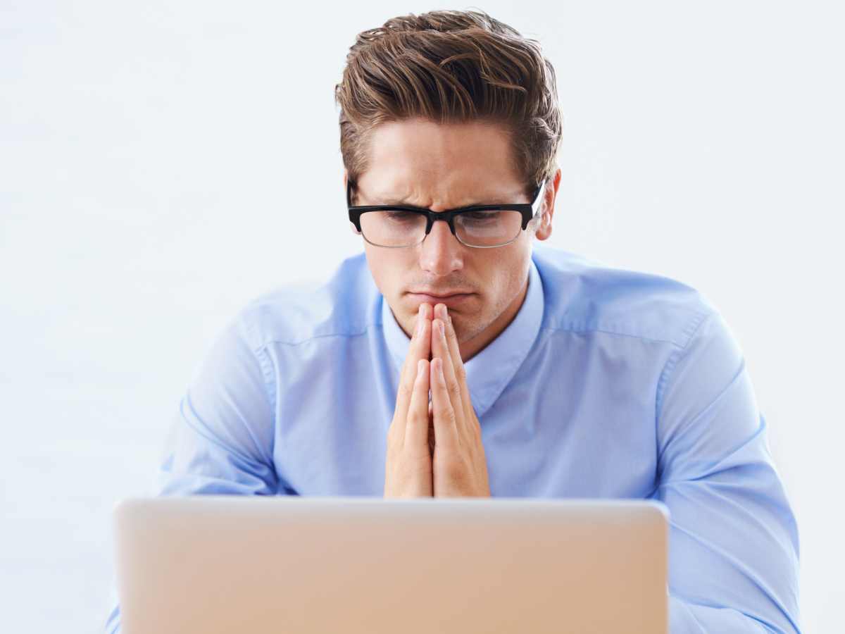 Man looking at his computer considering virtual EMDR for trauma therapy or PTSD treatment in Ballwin, MO. You can get help from an EMDR therapist near St. Louis, MO.