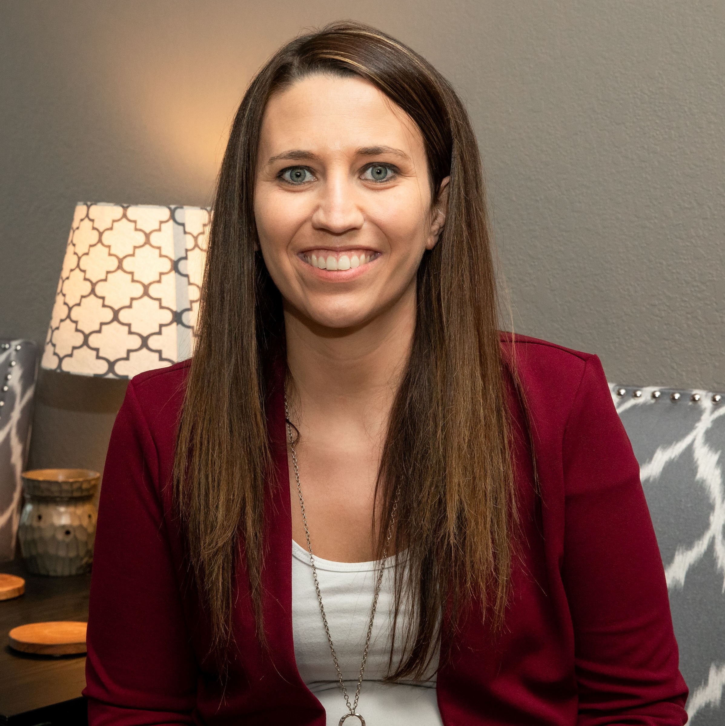 Marble Wellness therapist Diedre smiling at the camera. Meet with a Missouri trauma therapist for moms, dads, young adults, and more here! EMDR therapy, PTSD treatment, and more are available in Ballwin, MO with Diedre.