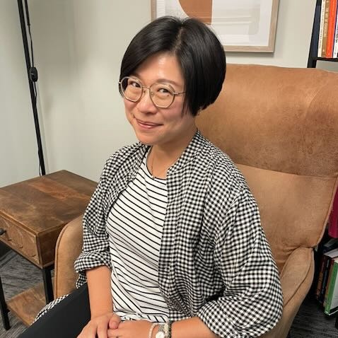 Harue Juang | Ballwin MO Child Therapist | Play Therapist in St. Louis Marble Wellness Therapist Harue, sitting in a chair at our Ballwin, MO therapy office looking at the camera. Meet with a Missouri online therapist for children, teens young adults, moms and more here!