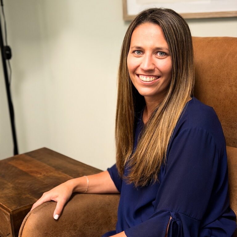 Marble Wellness therapist Deidre smiling at the camera. Meet with a Missouri trauma therapist for moms, dads, young adults, and more here! EMDR therapy, PTSD treatment, and more are available in Ballwin, MO with Deidre.